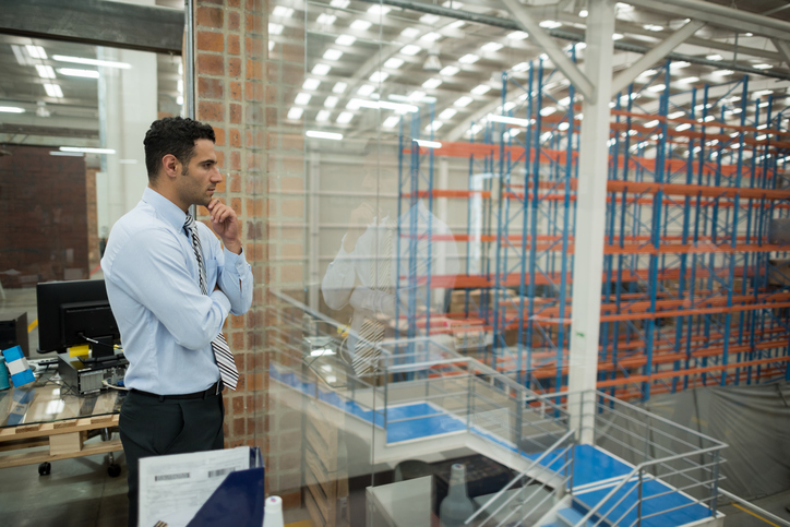 Man looks out into warehouse space.