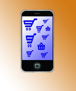 A phone against an orange background with ecommerce symbols on screen
