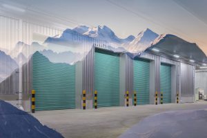 Warehouse doors interlinked with a mountaintop, which borders the top of the doors.