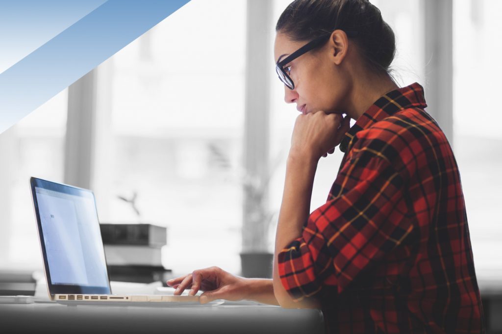 Young woman working on laptop on technical certification.